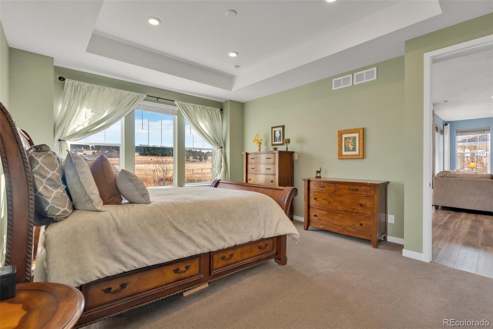 1122 Highpoint Trail Elizabeth, CO 80107 - Photo 26 of 45 a bedroom with a bed and dresser with mirror