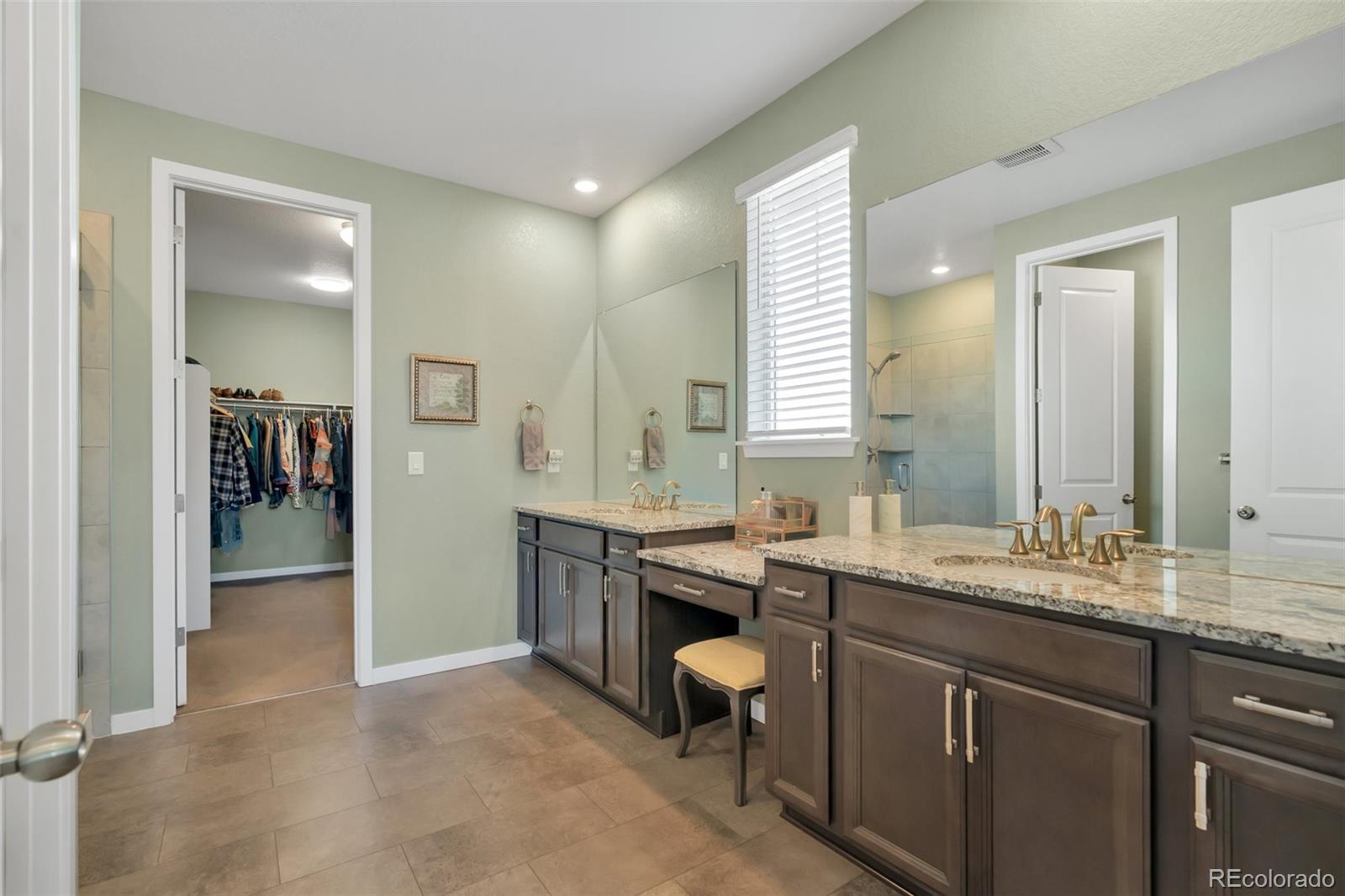 1122 Highpoint Trail Elizabeth, CO 80107 - Photo 27 of 45 a spacious bathroom with a granite countertop sink a mirror and a