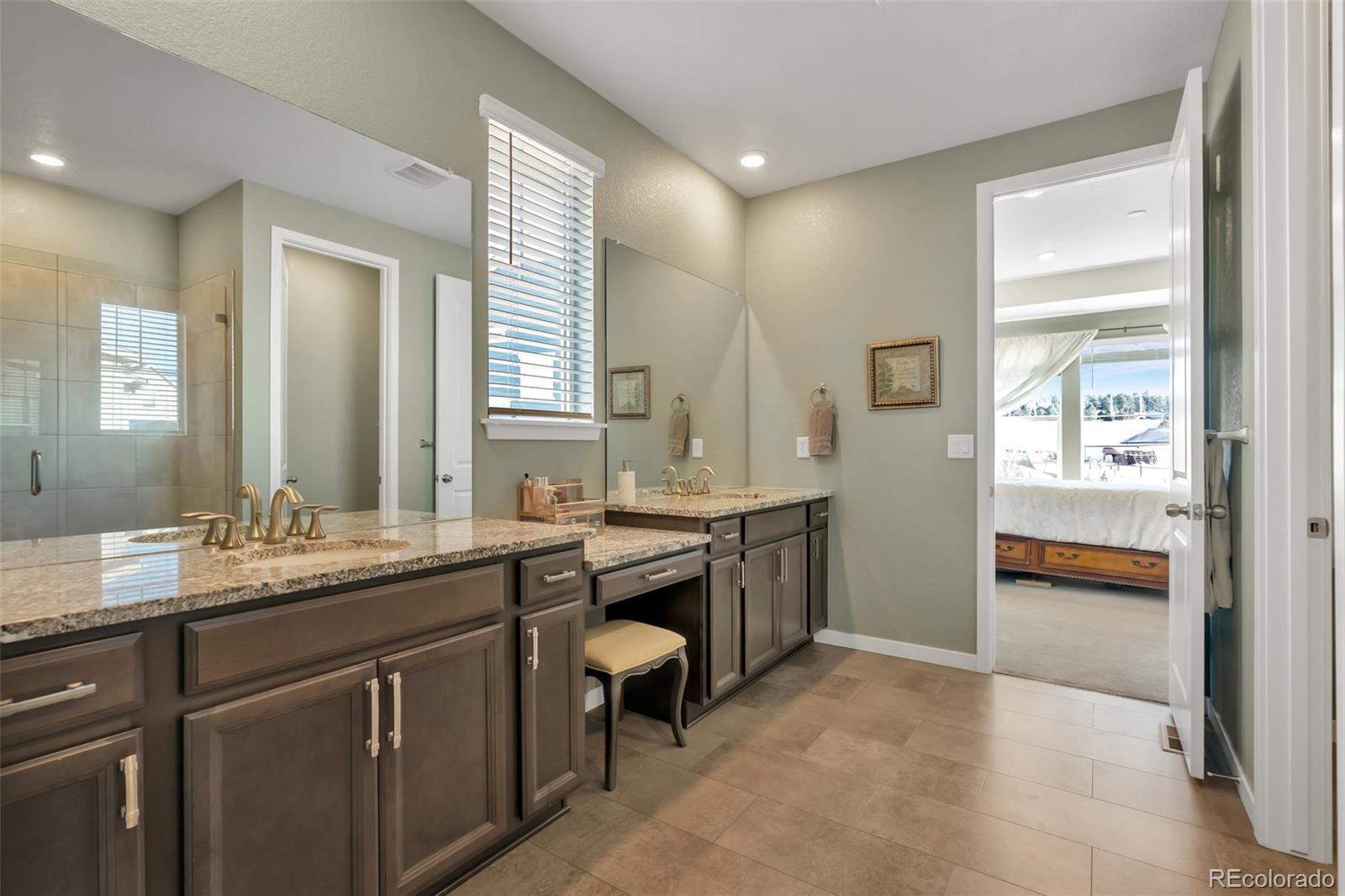 1122 Highpoint Trail Elizabeth, CO 80107 - Photo 28 of 45 a en suite bathroom with a sink and a mirror