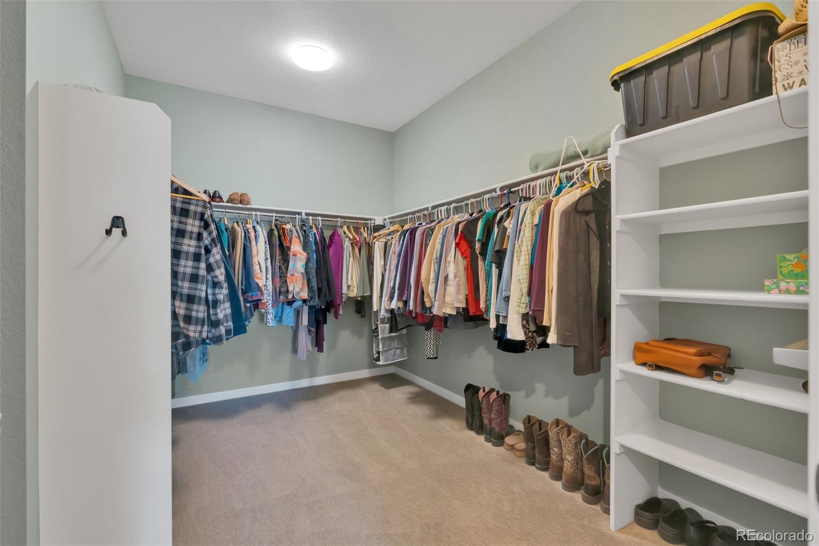 1122 Highpoint Trail Elizabeth, CO 80107 - Photo 30 of 45 a view of walk in closet with clothes and shoes