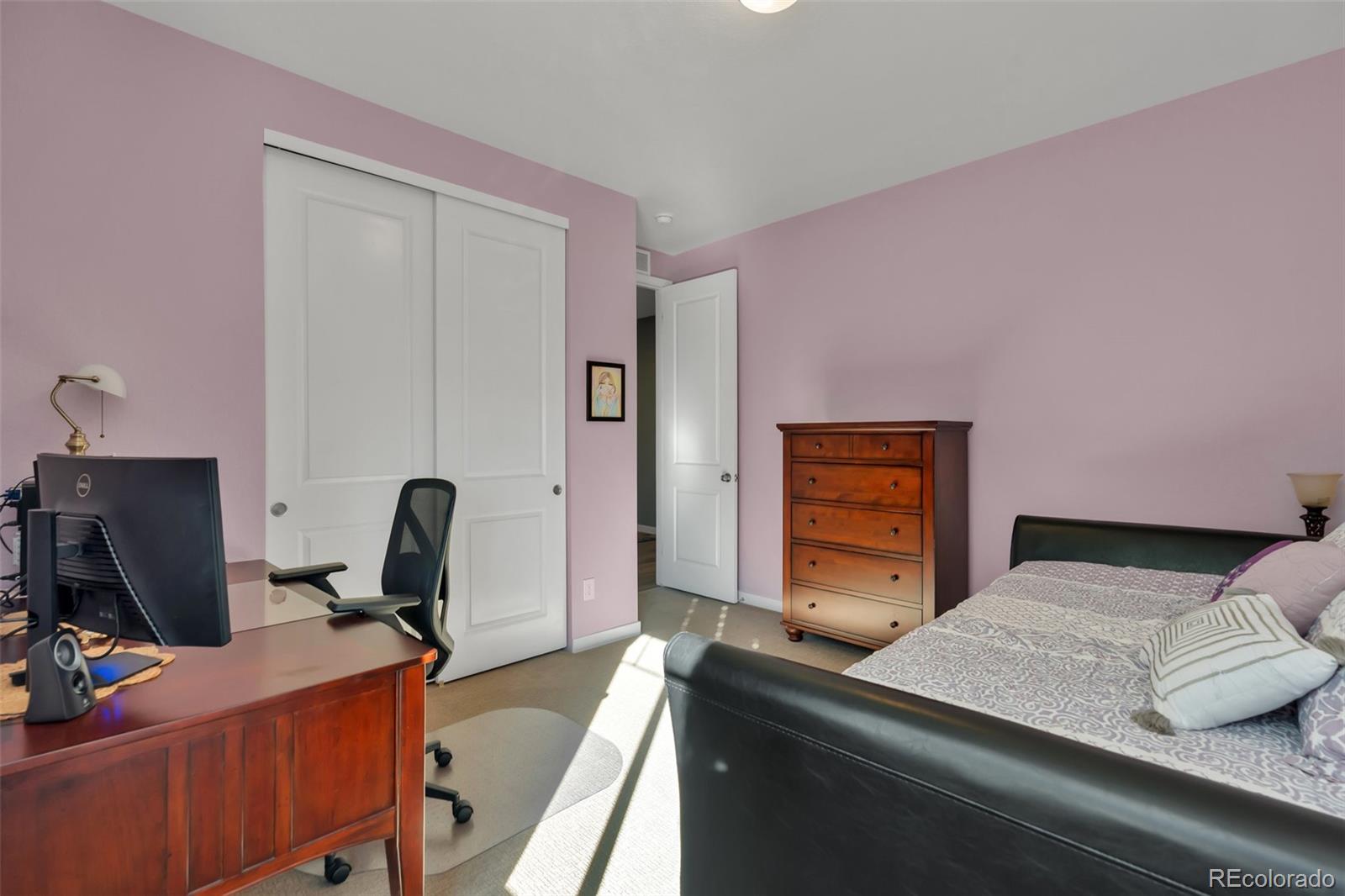 1122 Highpoint Trail Elizabeth, CO 80107 - Photo 34 of 45 a bedroom with a bed and a computer on a desk next to a window