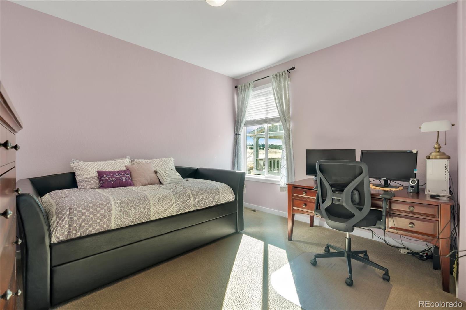 1122 Highpoint Trail Elizabeth, CO 80107 - Photo 35 of 45 a bedroom with a bed and a chair