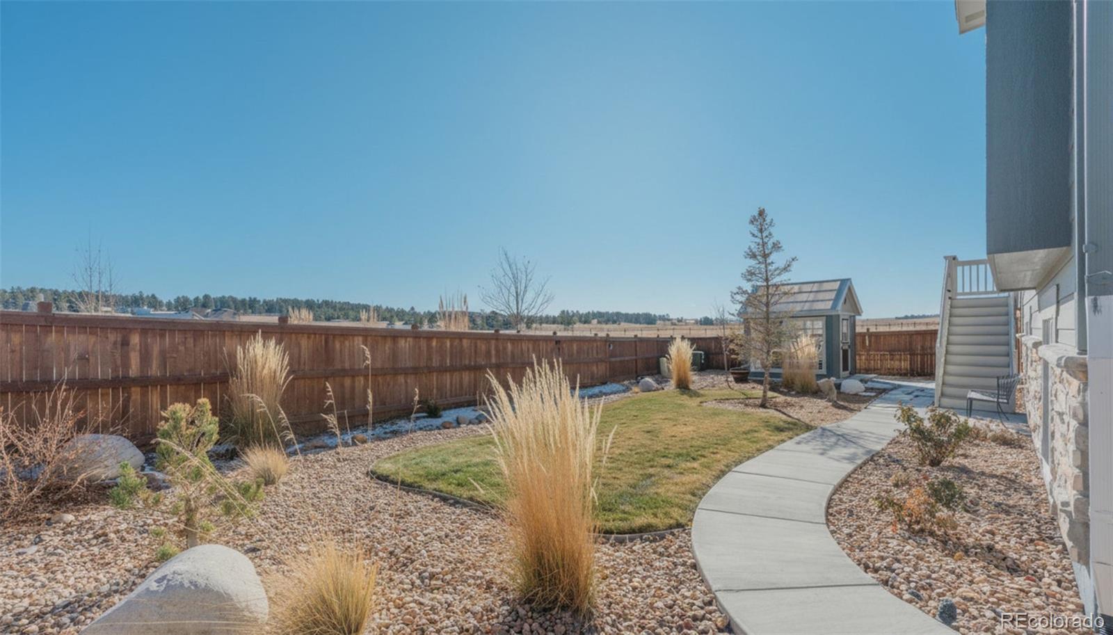 1122 Highpoint Trail Elizabeth, CO 80107 - Photo 41 of 45 a view of a swimming pool with a patio and a lake view