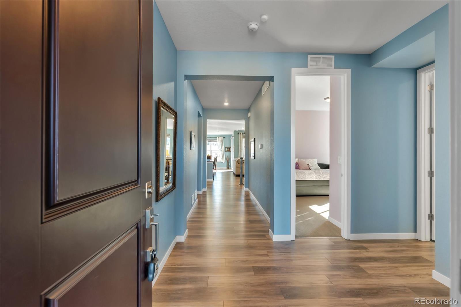 1122 Highpoint Trail Elizabeth, CO 80107 - Photo 8 of 45 a view of a hallway with wooden floor and staircase