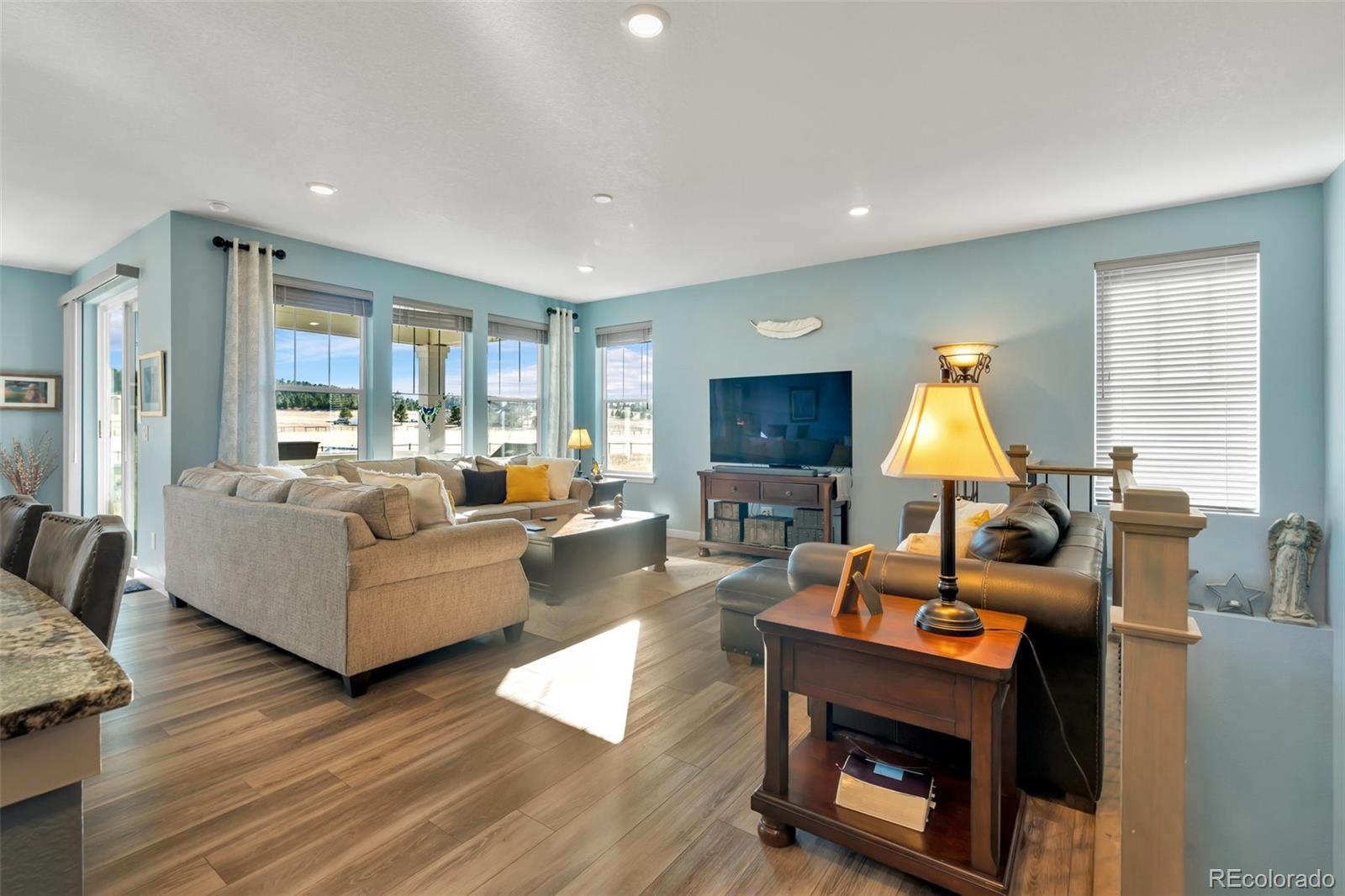 1122 Highpoint Trail Elizabeth, CO 80107 - Photo 10 of 45 a living room with furniture a large window and a fireplace