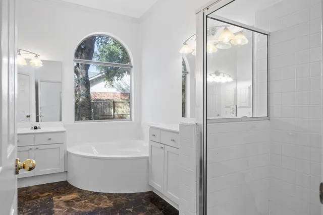 a bathroom with a sink mirror and window