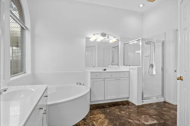 a view of an empty room with wooden floor fireplace and a window