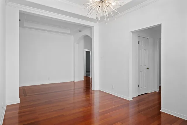 a kitchen with a refrigerator and countertop white cabinets