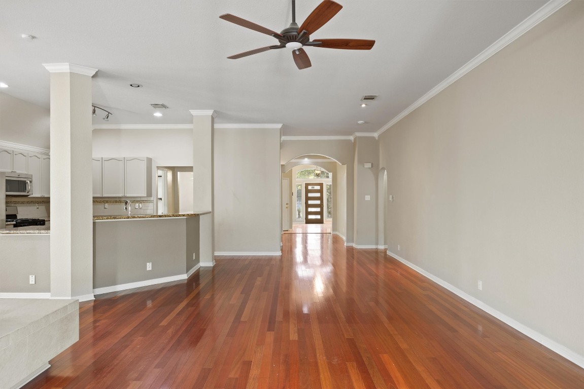 7124 Quimper Lane Austin, TX 78749 - Photo 33 of 40 a view of a kitchen with wooden floor and a ceiling fan