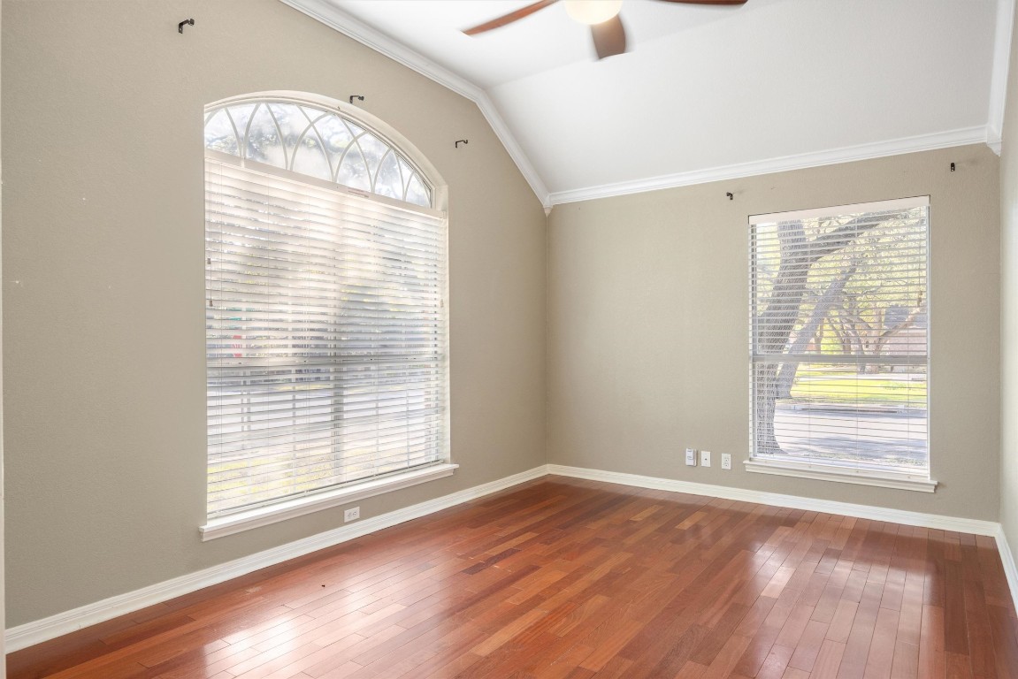 7124 Quimper Lane Austin, TX 78749 - Photo 5 of 40 an empty room with wooden floor and windows