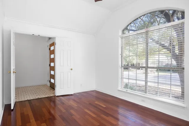 a view of a hallway view with wooden floor and staircase
