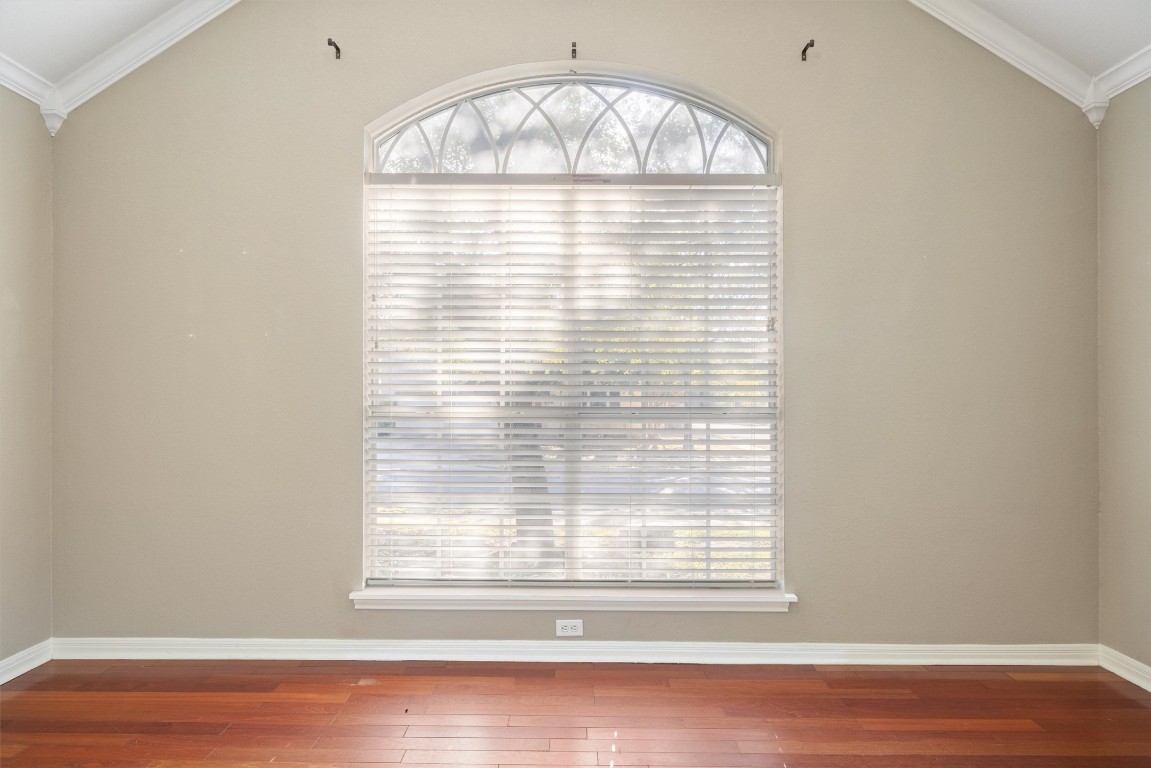 7124 Quimper Lane Austin, TX 78749 - Photo 6 of 40 an empty room with wooden floor and windows