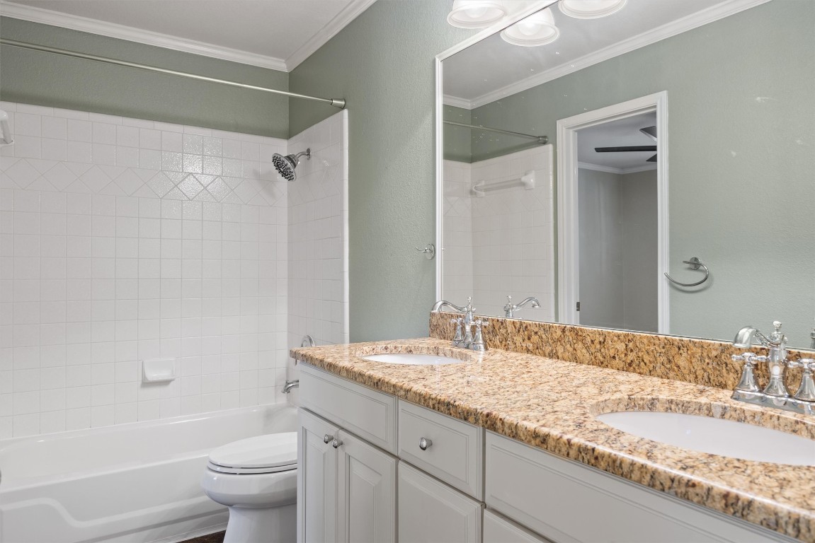 7124 Quimper Lane Austin, TX 78749 - Photo 9 of 40 a bathroom with a granite countertop sink toilet and shower