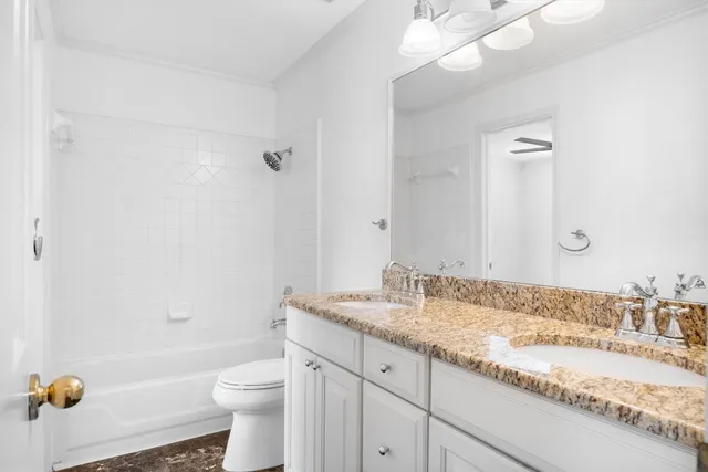 an empty room with chandelier fan and closet