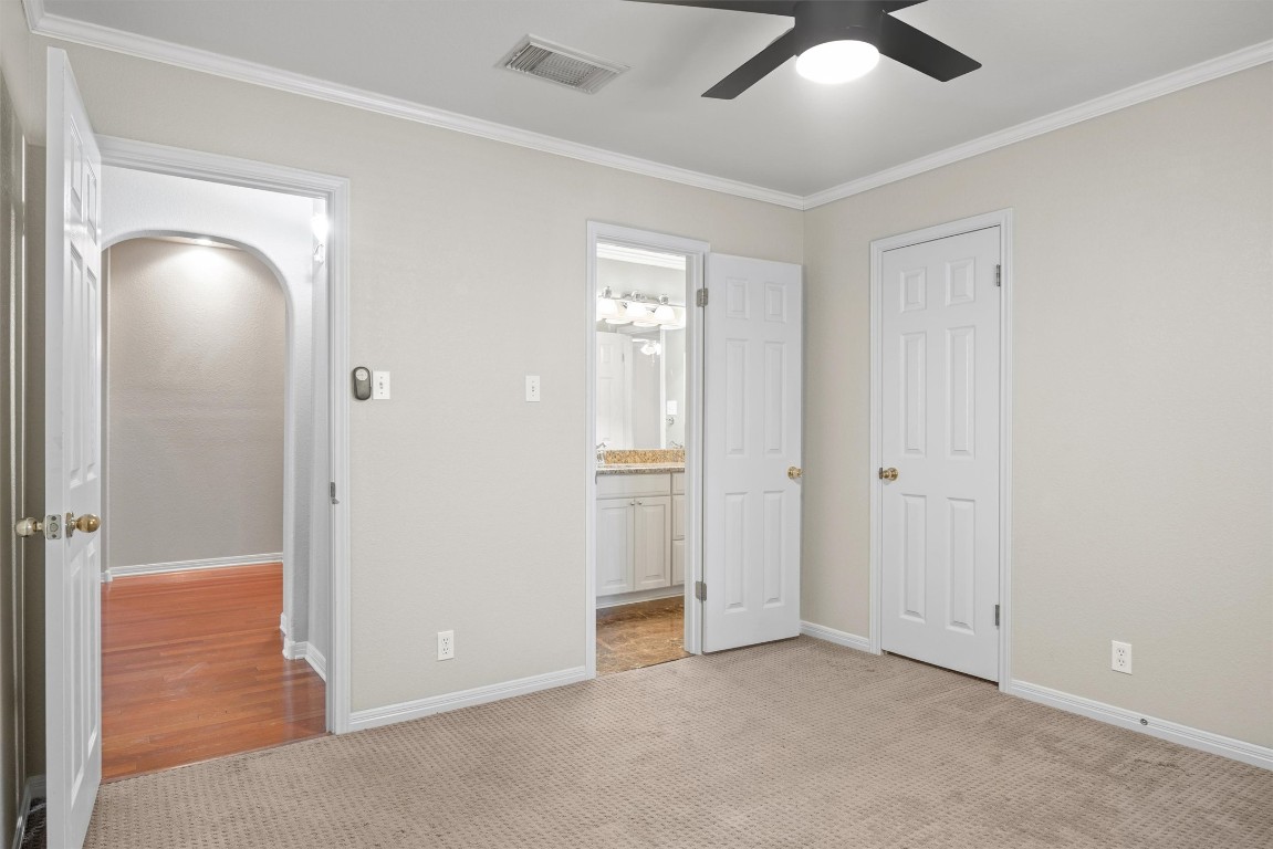 7124 Quimper Lane Austin, TX 78749 - Photo 10 of 40 an empty room with closet and a chandelier fan