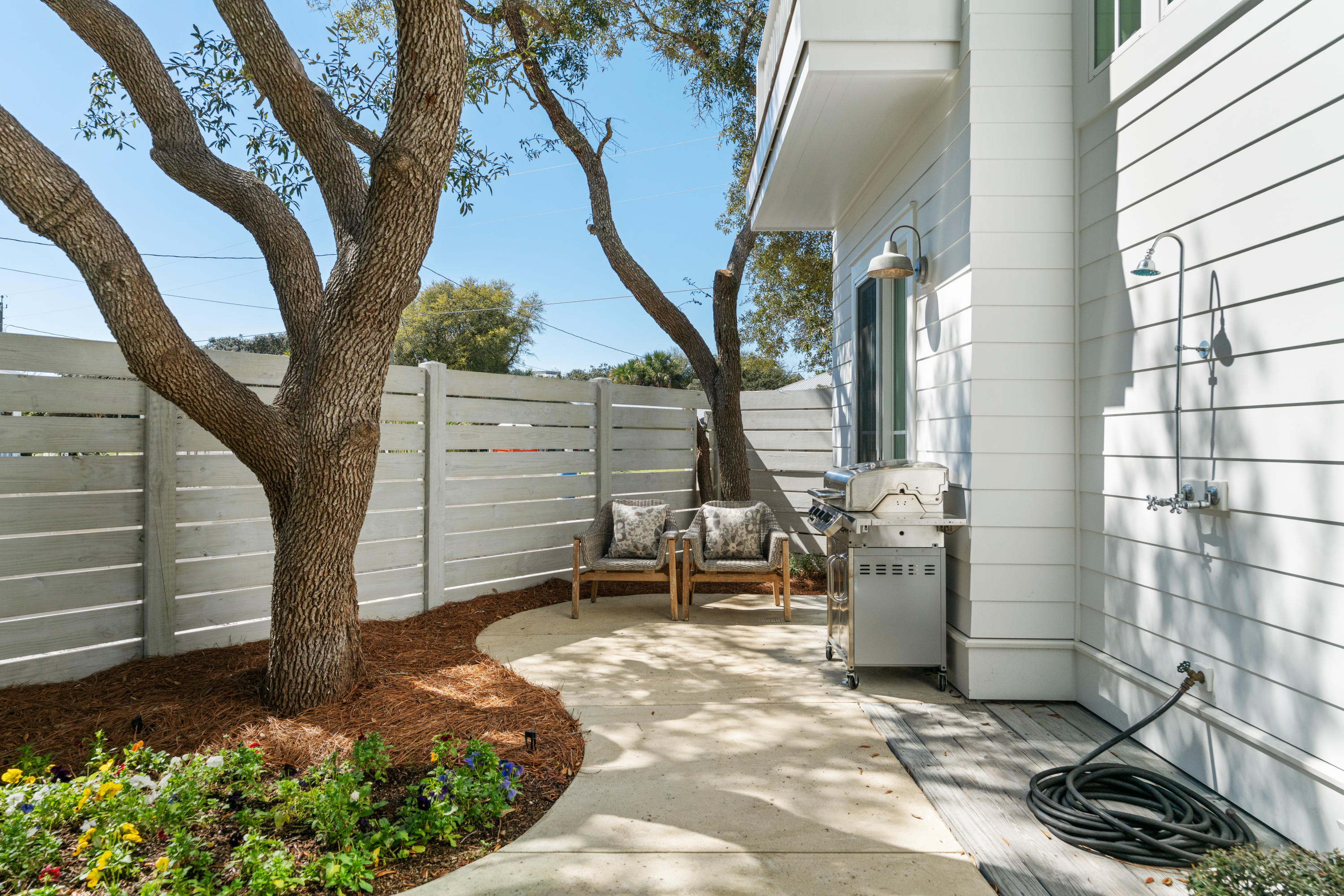 134 Blue Lake Road Santa Rosa Beach, FL 32459 - Photo 23 of 49 a view of a patio with table and chairs and potted plants