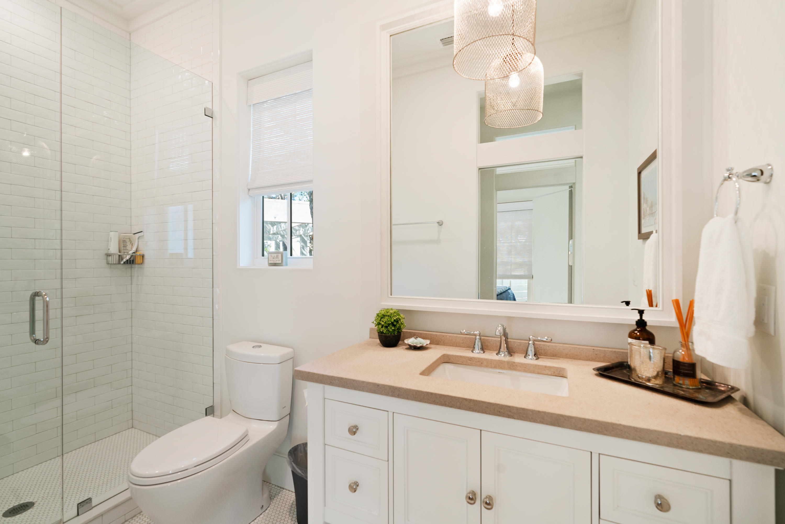 134 Blue Lake Road Santa Rosa Beach, FL 32459 - Photo 27 of 49 a bathroom with a granite countertop sink a toilet and a mirror