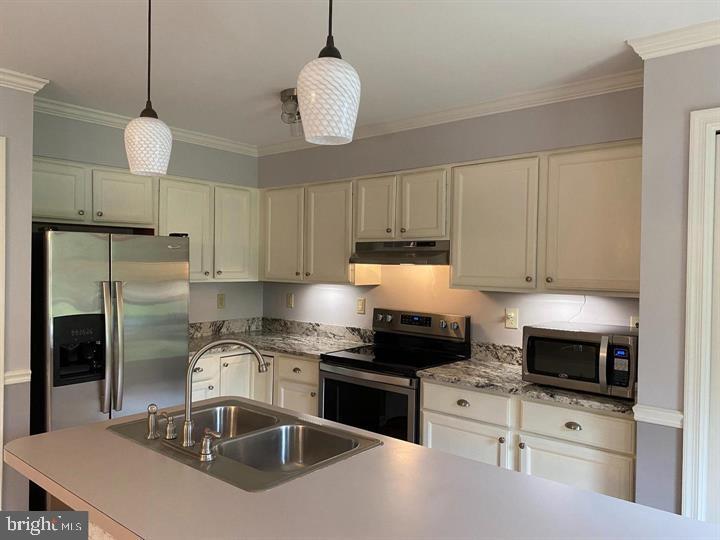 211 Morningside Drive Falling Waters, WV 25419 - Photo 11 of 42 a kitchen with granite countertop a sink stainless steel appliances and white cabinets