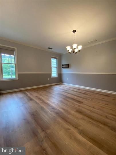211 Morningside Drive Falling Waters, WV 25419 - Photo 14 of 42 an empty room with wooden floor chandelier and windows
