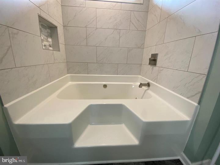 211 Morningside Drive Falling Waters, WV 25419 - Photo 30 of 42 a white bath tub sitting in a bathroom
