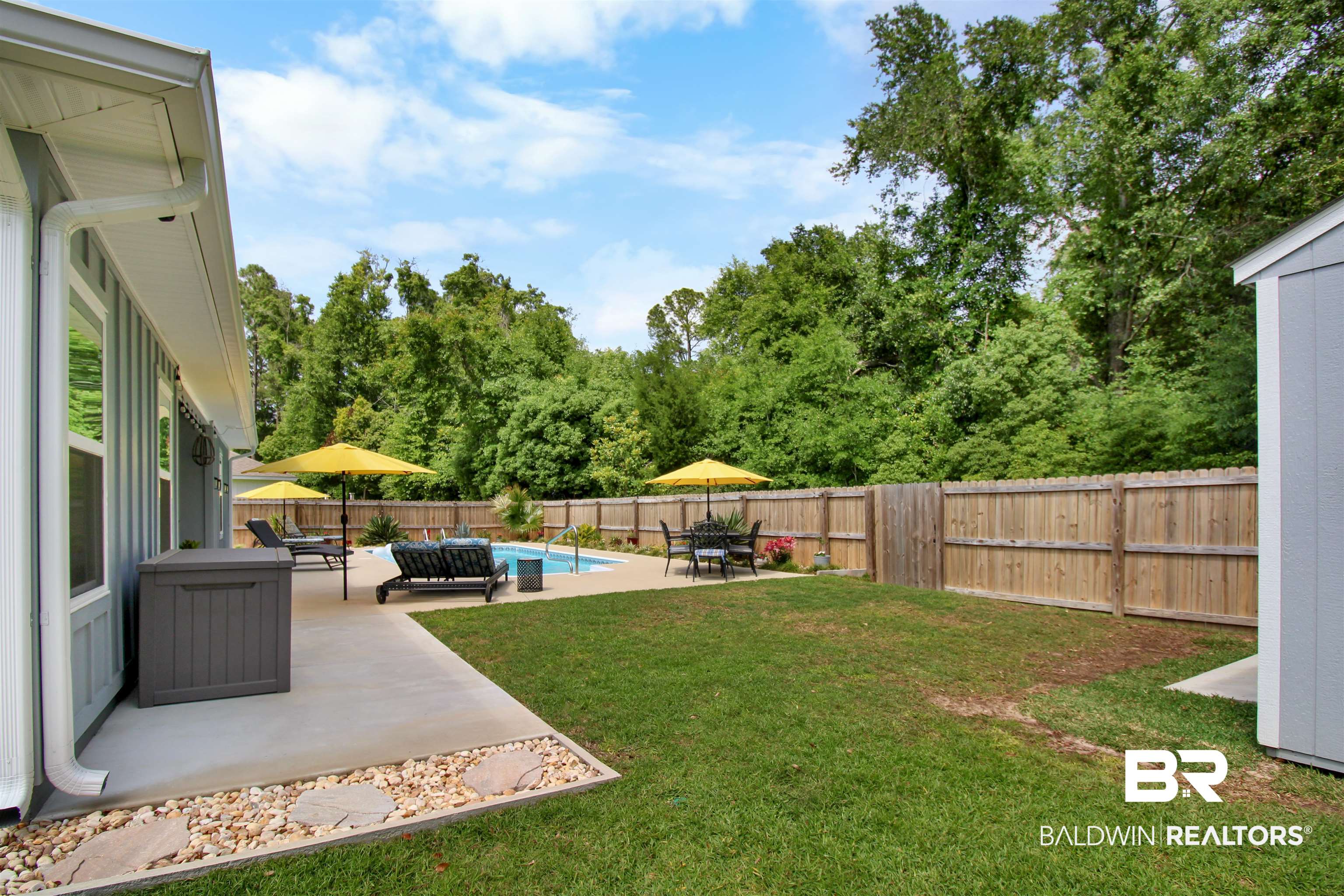 1885 Carly Street Foley, AL 36535 - Photo 34 of 40 Backyard featuring a privacy fence, an in-ground swimming pool, and a concrete patio