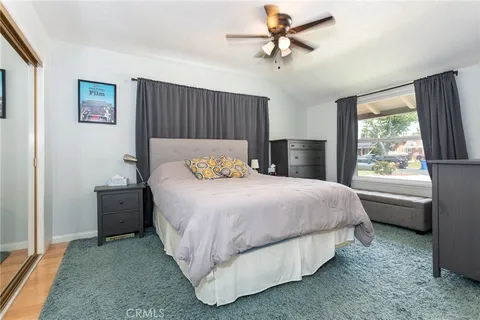 a spacious bedroom with a bed and a window