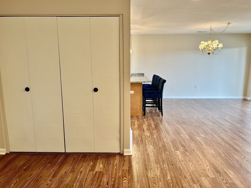 1006 Paradise Road, Unit 3R Swampscott, MA 01907 - Photo 11 of 34 a view of a room with wooden floor and chair