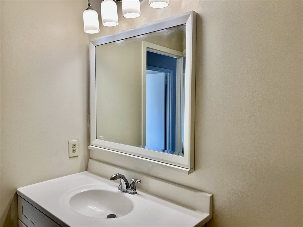 1006 Paradise Road, Unit 3R Swampscott, MA 01907 - Photo 13 of 34 a bathroom with a sink and a mirror