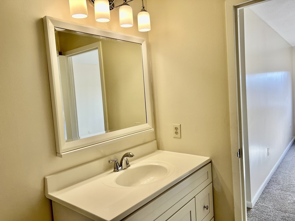1006 Paradise Road, Unit 3R Swampscott, MA 01907 - Photo 20 of 34 a bathroom with a sink and a mirror