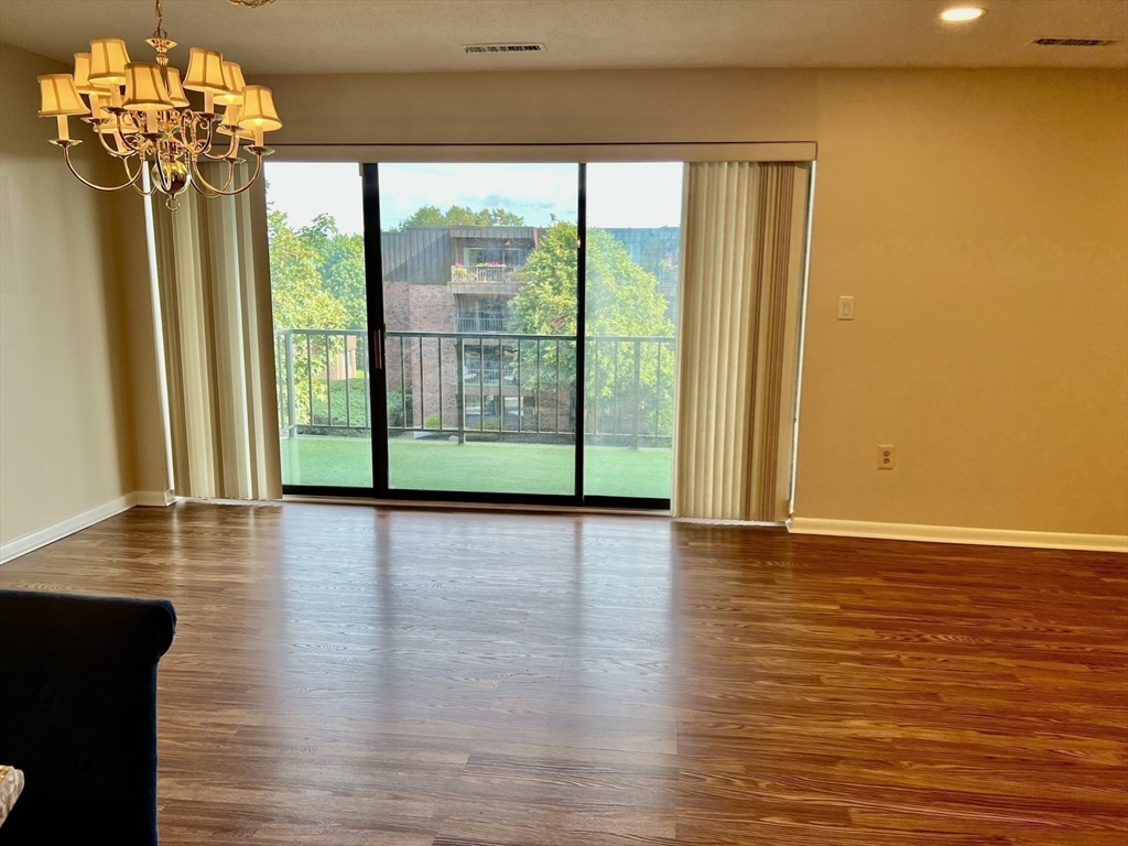 1006 Paradise Road, Unit 3R Swampscott, MA 01907 - Photo 9 of 34 a view of a room with wooden floor and large windows
