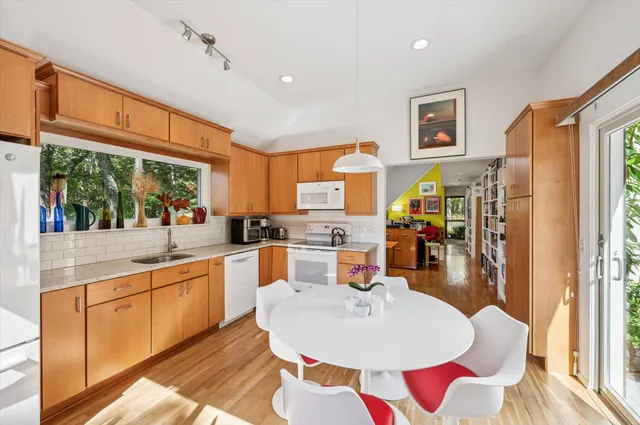 a large kitchen with a table and chairs in it