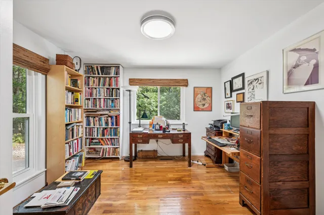 a living room with furniture and a book shelf