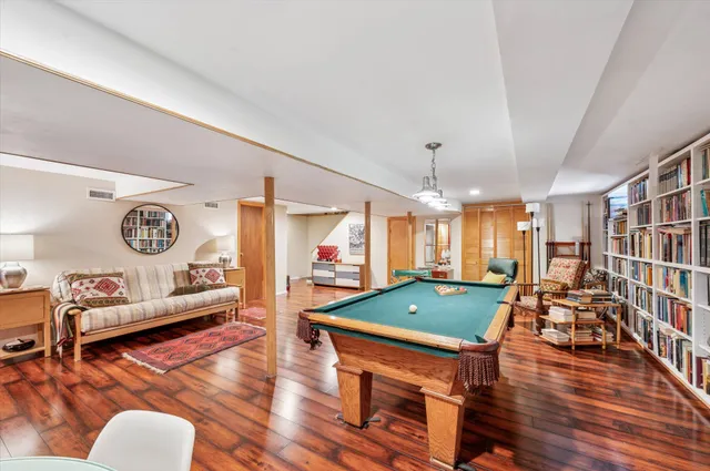 a room with lots of furniture and wooden floors