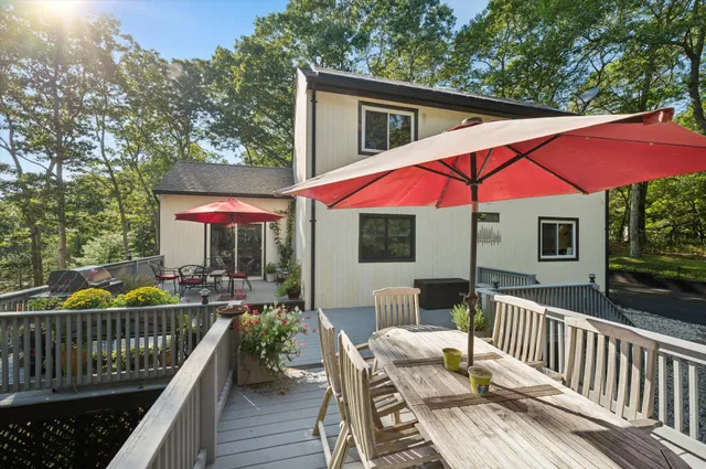 a view of a patio with a table and chairs under an umbrella