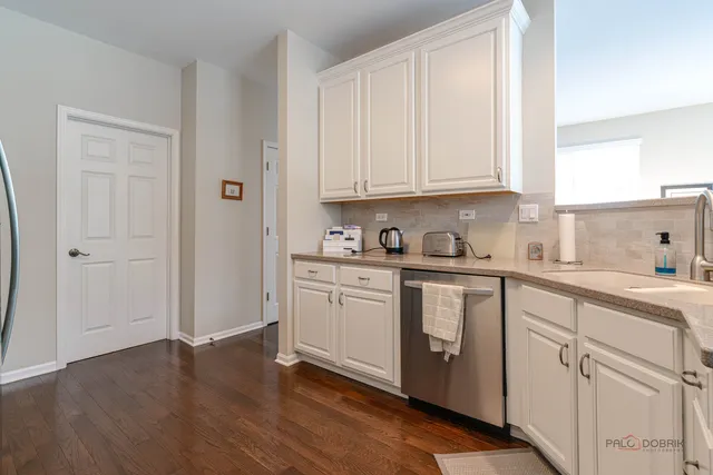 a kitchen with cabinets appliances and a window