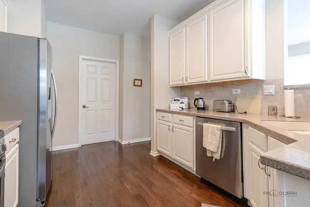 a kitchen with stainless steel appliances granite countertop a refrigerator sink and cabinets