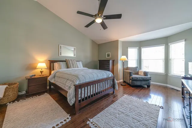 a bedroom with a bed couch and a window