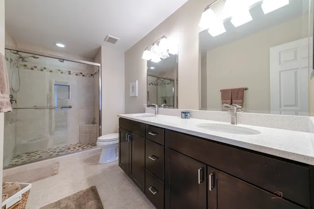 a bathroom with a double vanity sink mirror double shower and a bathtub