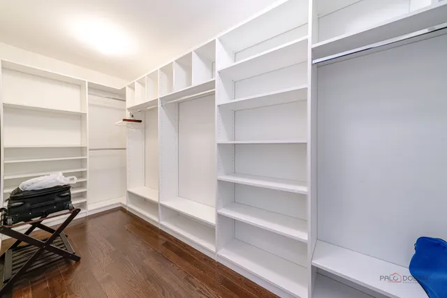 a view of walk in closet with empty racks