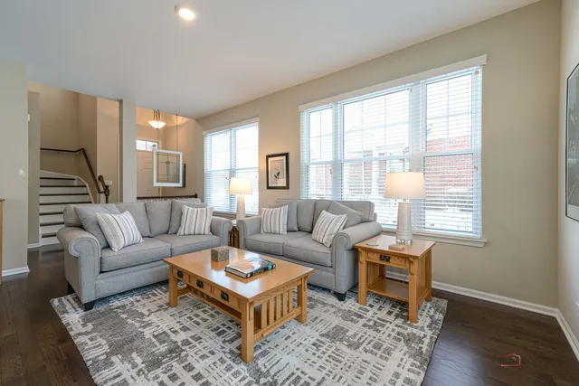 a living room with furniture wooden floor and a table