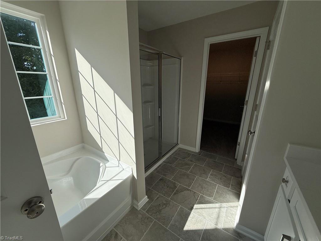 3171 Riley Ford Trail High Point, NC 27265 - Photo 35 of 40 Primary bath with tile floors and garden tub and 2 sinks