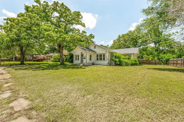 a house view with swimming pool and green space