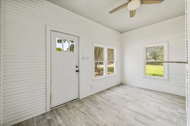 an empty room with windows and closet