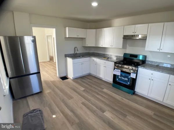 a kitchen with a refrigerator sink and stove