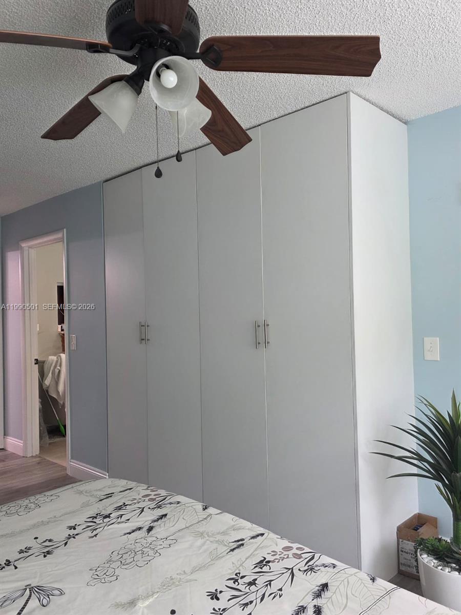 893 Southwest 120th Way Davie, FL 33325 - Photo 13 of 22 a bedroom with a bed and a chandelier