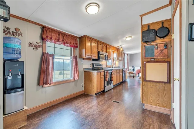 a kitchen with stainless steel appliances granite countertop a stove a sink and a refrigerator