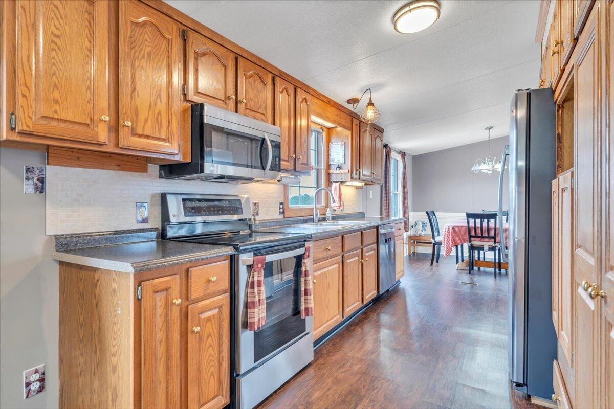 627-641 Novelty Road Penhook, VA 24137 - Photo 18 of 69 a kitchen with stainless steel appliances granite countertop a stove a sink and a refrigerator