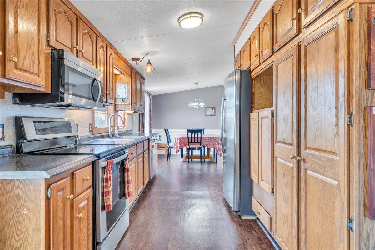 627-641 Novelty Road Penhook, VA 24137 - Photo 19 of 69 a kitchen with stainless steel appliances granite countertop lots of counter top space and wooden floor