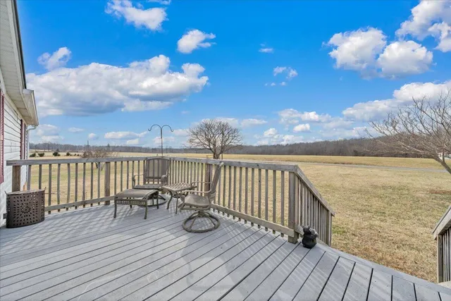 a bedroom with a bed dresser and wooden floor