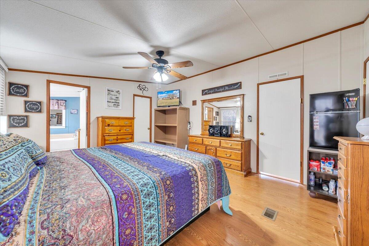 627-641 Novelty Road Penhook, VA 24137 - Photo 23 of 69 a spacious bedroom with a bed a dresser and a large window